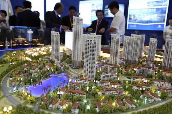 Models of apartment buildings displayed at the on-going 18th China International Fair for Investment and Trade in Xiamen, Fujian province. Developers are cutting prices to spur sales after volume dropped in the first eight months of the year. ZHU XINGXIN/CHINA DAILY  