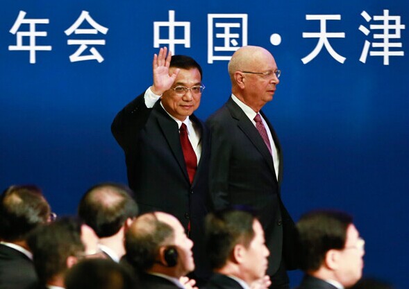 Premier Li Keqiang and Klaus Schwab, founder and executive chairman of the World Economic Forum, attend the opening ceremony of the Summer Davos forum on Wednesday in Tianjin. [Photo by Feng Yongbin/China Daily]  