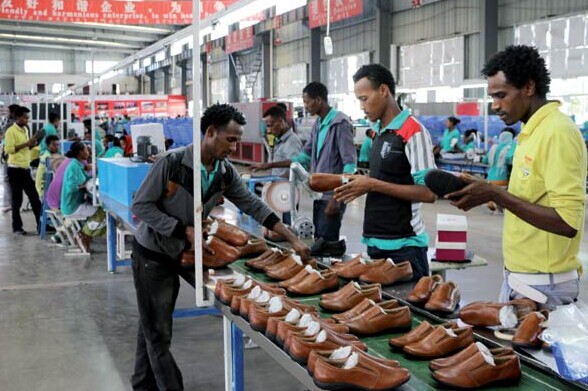 Workers operate on the production line in the Dukem, Addis Ababa, workshop of Huajian International Shoe City (Ethiopia) Plc. CHEN WEIHUA/CHINA DAILY