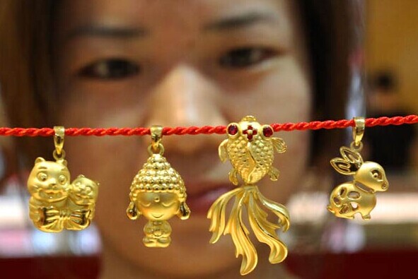 Gold ornaments sold in Suzhou, Jiangsu province. China may launch its gold exchange in Shanghai on Thursday, the first yuan-denominated gold trading board that will be open to overseas investors. WANG JIANZHONG/CHINA DAILY  