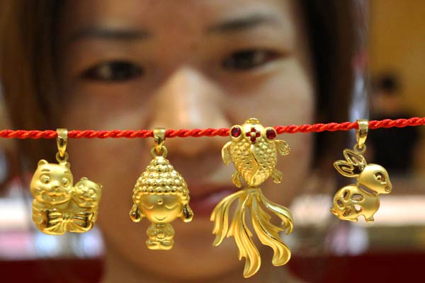 Gold ornaments sold in Suzhou, Jiangsu province. China may launch its gold exchange in Shanghai on Thursday, the first yuan-denominated gold trading board that will be open to overseas investors. WANG JIANZHONG/CHINA DAILY