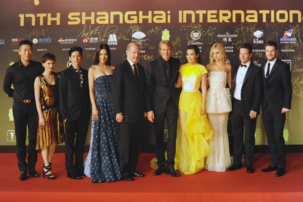 Transformers: Age of Extinction director Michael Bay (fifth from right) and its cast, including Chinese actress Li Bingbing (fourth from right), attend the 17th Shanghai International Film Festival in June. China's film market has been growing rapidly over the past decade and is looking to move toward a burgeoning movie industry. CHINA DAILY