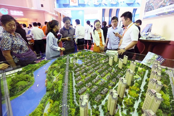 Visitors at a housing fair in Beijing in September. Despite sluggishness in the mass residential market, sales in the high-end market in Beijing and Shanghai remain good. [Photo provided to China Daily]