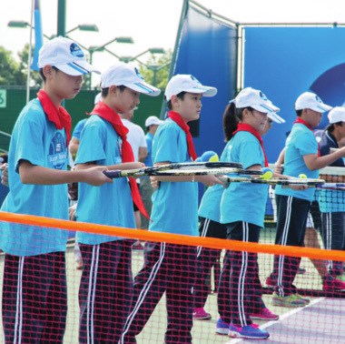 Young candidates taking tennis lessons sponsored by ANZ at a coaching center in Shanghai. [Provided to China Daily]