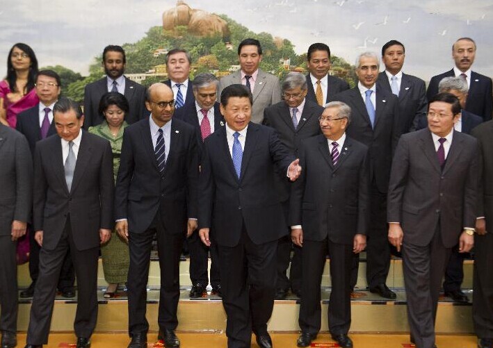 Chinese President Xi Jinping (C, front) meets with representatives of 21 Asian countries who signed the Memorandum of Understanding on Establishing Asian Infrastructure Investment Bank (AIIB) in Beijing, capital of China, Oct. 24, 2014. (Xinhua/Huang Jingwen)