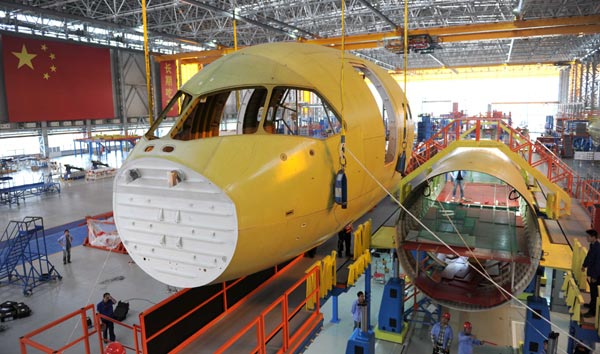 Workers of Commercial Aircraft Corporation of China Ltd assemble parts of a C919 aircraft in Shanghai. China's high-tech manufacturing sector is growing faster than the overall pace of manufacturing this year. [Yu Ping / For China Daily]