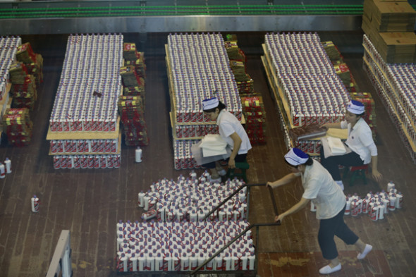 Workers in the town of Moutai, Guizhou province, inspect consignments of the liquor in October. [Photo provided to China Daily]