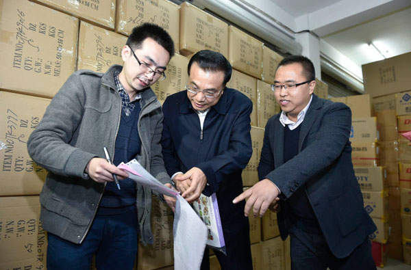 Premier Li Keqiang visits China's leading e-commerce village in Qingyanliu, Zhejiang province, on Wednesday. The village is a hotspot of ecommerce shops and has more than 20 delivery companies. PHOTO BY WANG YE / XINHUA