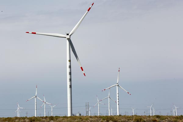 A wind farm in Hami, Xinjiang Uygur autonomous region. China is set to cap carbon dioxide emissions by 2030 and increase the share of nonfossil energy in total primary energy supply to about 20 percent by then. CAI ZENGLE / FOR CHINA DAILY  