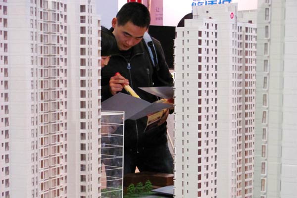 Potential house buyers visit a recent property exhibition in Beijing.[Provided to China Daily]   