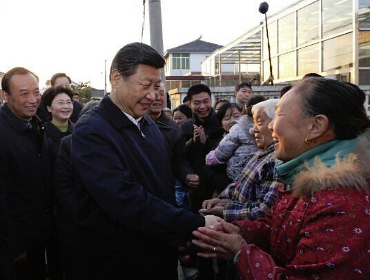 Chinese President Xi Jinping, also general secretary of the Communist Party of China (CPC) Central Committee and chairman of the Central Military Commission, shakes hands with local villagers as he visits the Yongmaoxu Village under Shiye Town in Dantu District of Zhenjiang City, east China's Jiangsu Province, Dec. 13, 2014. Xi made an inspection tour in Jiangsu Province from Dec. 13 to 14, 2014. (Xinhua/Lan Hongguang)