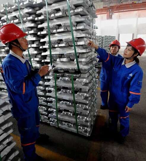 Technicians inspect aluminum ingots for export at the Aluminum Corp of China Ltd's Guangxi branch. Sun Zhaoxue became general manager of Chalco from 2013. LUO ZHIKEN/FOR CHINA DAILY  