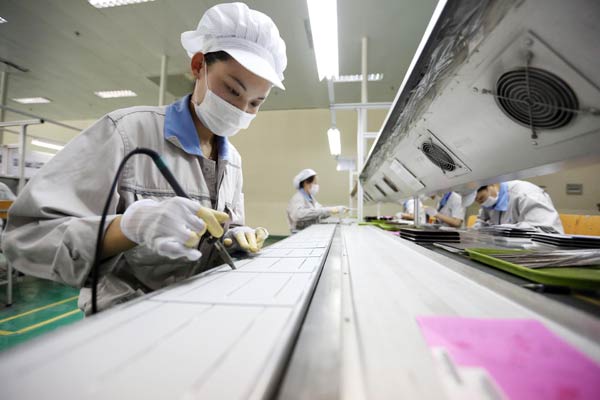 Workers at a solar panel factory in Lianyungang, Jiangsu province. The US Department of Commerce has ruled that solar products from China were dumped in the US market and manufacturers were subsidized by the government.SI WEI/CHINA DAILY   