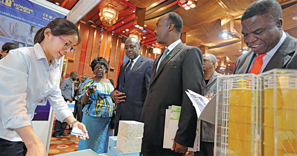 African executives attend a trade fair in Beijing. Experts say China needs to take a more comprehensive approach to invest in Africa. Provided to China Daily