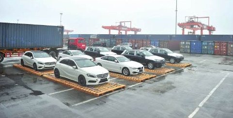 Cars imported from Europe are unloaded at the Chongqing Railway Station. Vehicle imports are projected to grow about 10 percent next year.WANG ZHENGWEI/FOR CHINA DAILY  