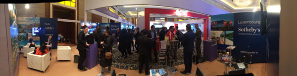 Potential Chinese investors crowd at Realogics Sothebys International Realty (RSIR)s booth at the 2014 Luxury Properties Showcase in Shanghai at the Marriott City Centre on Dec 13. Provided to China Daily 