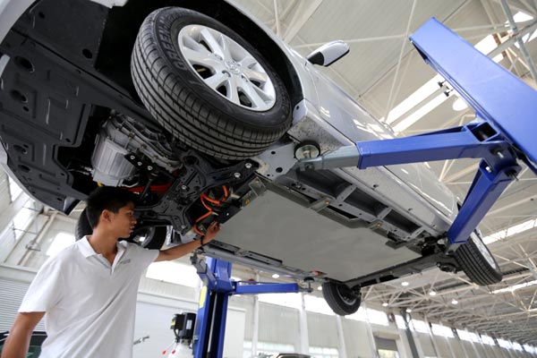 A technician checks a car battery at the production line at BJEV, the new-energy vehicle arm of BAIC Motor, in Beijing.  Wang Zhen / For China Daily