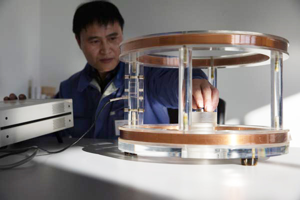 Rare earths products being tested by a scientist at a high-tech company in Beijing. China has ended its quota system previously aimed at restricting exports of rare earths. [Photo/Xinhua]