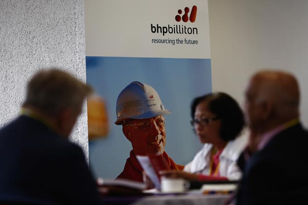 BHP Billiton Ltd shareholders wait in a refreshment area ahead of the company's annual general meeting in London, UK, on Oct 23,2014.The world's biggest mining firm told investors that first-quarter iron ore output rose 17 percent as it continues to expand production in the face of tumbling prices. [Photo/China Daily]  