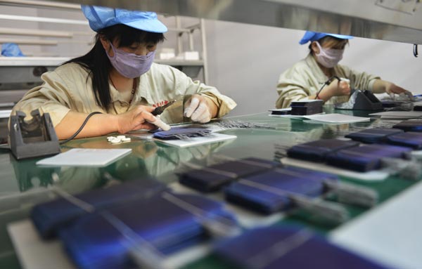 Workers soldering components at Hilight Solar Co Ltd, Zouping county, Shandong province. The private sector has become the driver of job creation in China. [Photo/China Daily]  