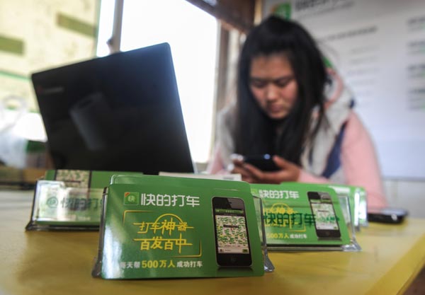 An employee from taxi-hailing app company Kuaidi Dache helping a customer install the software. Launched in 2012, Kuaidi has linked up with more than 1 million taxis in more than 300 cities across China, including Hong Kong. [Photo/Xinhua]
