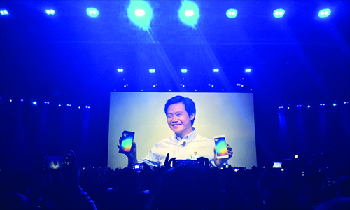 Lei Jun, founder of Xiaomi Inc, holds the company's latest flagship phones at a launch event in Beijing on Thursday. Photo: Li Qiaoyi/GT
