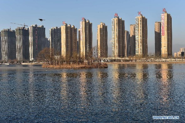 Photo taken on Jan. 16, 2015 shows residential buildings in Taiyuan, capital of north China's Shanxi Province. Home prices declined in most Chinese cities in December as 66 saw month-on-month price drops among 70 surveyed cities, the National Bureau of Statistics announced on Jan. 18, 2015. (Xinhua/Zhan Yan)