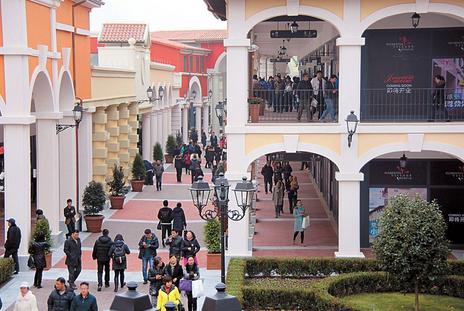 Shoppers walk at the Florentia Village  Shanghai Luxury Designer Outlet, which opened yesterday in Shanghai. RDM Group, the owner of Florentia Village brand, plans to open another five luxury designer outlets in China within the next three years for the Italian company to tap the growing purchasing power of Chinese consumers.  Zhang Suoqing
