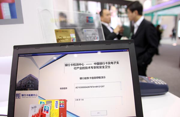 A China UnionPay stand at a network security promotion week in Beijing shows the vulnerability of magnetic stripe bank cards and promotes the use of cards with chips. [Photo/China Daily] 