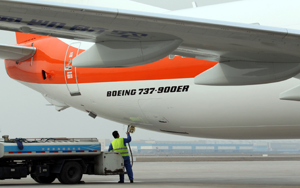 A Boeing 737-900ER aircraft, delivered to Okay Airways, lands in Tianjin on Monday. [Photo provided to China Daily]