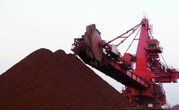 Iron ore being unloaded at Rizhao Port, Shandong province. [Photo provided to China Daily]  