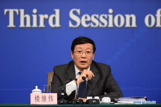 Journalists continue to ask questions from Chinese finance minister Lou Jiwei after a press conference for the third session of China's 12th National People's Congress (NPC) on fiscal and tax reform, in Beijing,capital of China, March 6, 2015. (Xinhua/Yin Gang)