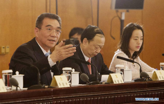 Justin Yifu Lin (1st L), a member of the 12th National Committee of the Chinese People's Political Consultative Conference (CPPCC), answers questions during a press conference on major economic issues for the third session of the 12th CPPCC National Committee in Beijing, capital of China, March 6, 2015. Members of the 12th CPPCC National Committee Li Yining, Li Yizhong, Chen Xiwen, Justin Yifu Lin, Yang Kaisheng, Chang Zhenming, Jia Kang answered questions at the press conference. (Xinhua/Lyu Xun)
