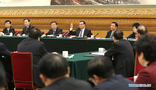 Chinese Premier Li Keqiang (back, 3rd R), also a member of the Standing Committee of the Political Bureau of the Communist Party of China Central Committee, joins a discussion with deputies to the 12th National People's Congress (NPC) from east China's Jiangsu Province during the third session of the 12th NPC, in Beijing, capital of China, March 7, 2015. (Xinhua/Ma Zhancheng)