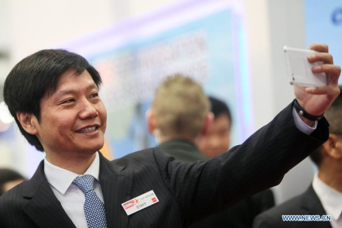 China's Xiaomi Tech's CEO Lei Jun takes a selfie with his cellphone at 2015 CeBIT Technology Trade fair in Hanover, Germany, on March 16, 2015.  (Xinhua/Zhang Fan)
