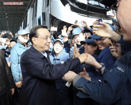 Chinese Premier Li Keqiang (L front) inspects CNR Changchun Railway Vehicles Co., Ltd in Changchun, capital of northeast China's Jilin Province, April 10, 2015. Li made an inspection tour in Jilin from April 9 to 10. (Xinhua/Ding Lin)