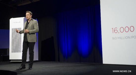 Elon Musk, CEO of Tesla, unveils a suit of batteries for homes, businesses, and utilities at Tesla Design Studio in Hawthorne, California, the United States, April 30, 2015. (Xinhua/Yang Lei)