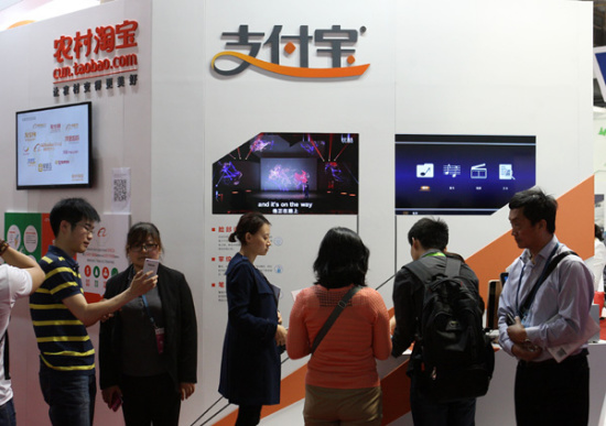 Alipay, the third-party online payment arm of Alibaba Group Holding Ltd, promotes its rural payment services and rural e-commerce at an expo in Beijing on Wednesday. (Photo/China Daily)
