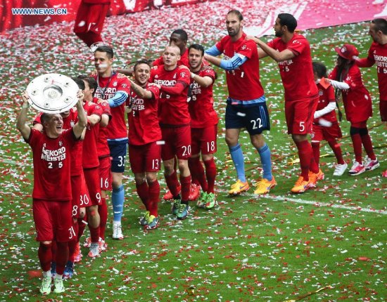 Bayern Munich's players celebrate with the trophy after the German first division Bundesliga football match between Bayern Munich and Mainz in Munich, Germany, on May. 23, 2015. Bayern Munich won 2-0 and claimed their 25th Bundesliga title. (Xinhua/Philippe Ruiz)