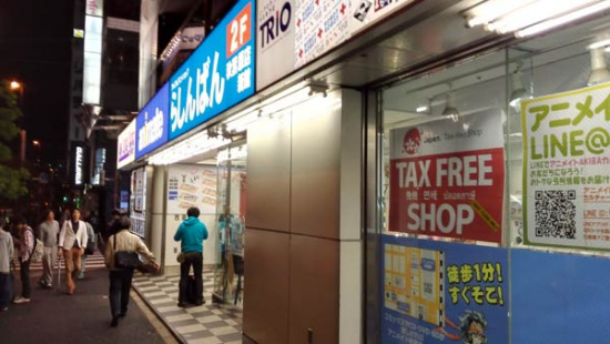 A shop selling animation-related products at downtown Tokyo's Akihabara district tries to attract foreign visitors with a sign saying tax free shop in languages that include English, Chinese and Korean, in April. (Zhang Yunbi/China Daily)