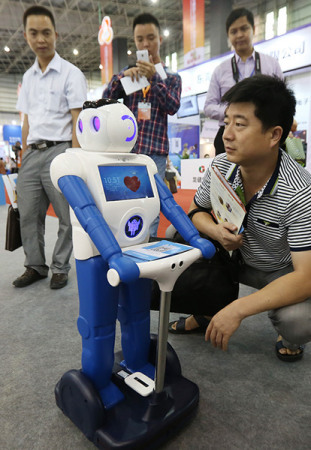 A robot on display at the China Processing Trade Products Fair, which opened in Dongguan, Guangdong province, on Wednesday. The robot can talk in simple words with its owner and do some simple domestic chores such as turning on and off TV sets. (Photo/China Daily)