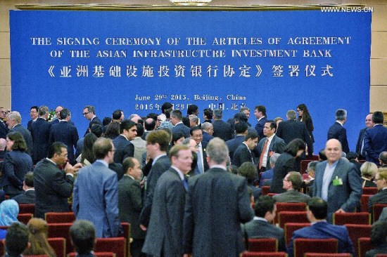 Representatives of prospective founders of the Asian Infrastructure Investment Bank (AIIB) prepare to attend the signing ceremony of the articles of agreement of AIIB in Beijing, capital of China, June 29, 2015. (Photo: Xinhua/Li Xin)