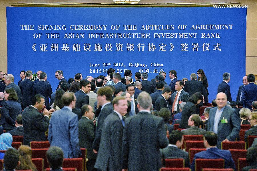 Representatives of prospective founders of the Asian Infrastructure Investment Bank (AIIB) prepare to attend the signing ceremony of the articles of agreement of AIIB in Beijing, capital of China, June 29, 2015. (Photo: Xinhua/Li Xin)