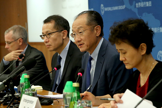 World Bank Group President Jim Yong Kim (second from right), speaks at a news conference in Beijing on Friday. Kim said China's economy is strong and its fundamentals are sound, while lauding the government's reform efforts. [Photo provided to China Daily by Wu Zhiyi]