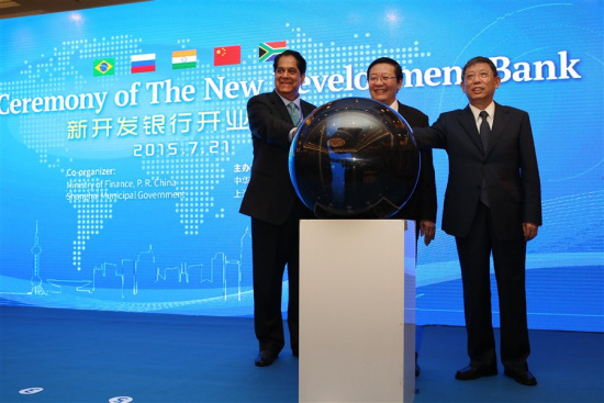 Shanghai Mayor Yang Xiong (R), Chinese Finance Minister Lou Jiwei (M) and K.V. Kamath, president of the New Development Bank(L), celebrate together as the New Development Bank, more commonly known as the BRICS Bank, was officially launched in Shanghai today. (Photo: Shanghaidaily/Wang Rongjiang)