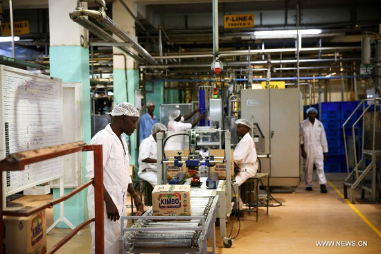 Workers work on a production line in Bidco's factory, on the outskirts of Nairobi, Kenya, on July 21, 2015. (Photo: Xinhua/Pan Siwei)