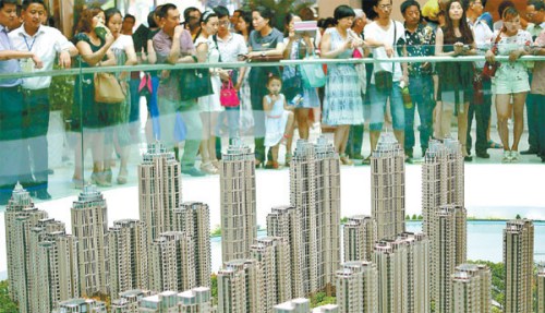 Realty prices continue recovery Potential buyers check out the model of a new housing project at a real estate firm in Yichang, Hubei province. Sales of new homes across 30 cities, monitored by E-house China R&D Institute, declined 5.5 percent in July. (Photo provided to China Daily)