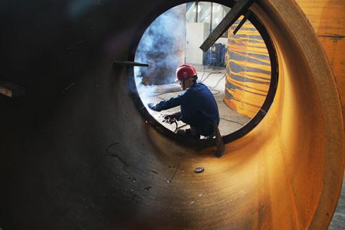 A worker doing soldering at a factory in Nantong, Jiangsu province. Known as the world's factory, China is embarking on a round of industrial consolidation as part of the 'Made in China 2025' national plan to reinvigorate the manufacturing sector.(Xu Ruiping/For China Daily)