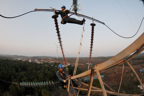 Workers check power transmission lines in Mingguang, Anhui province. (Photo proided to China Daily)