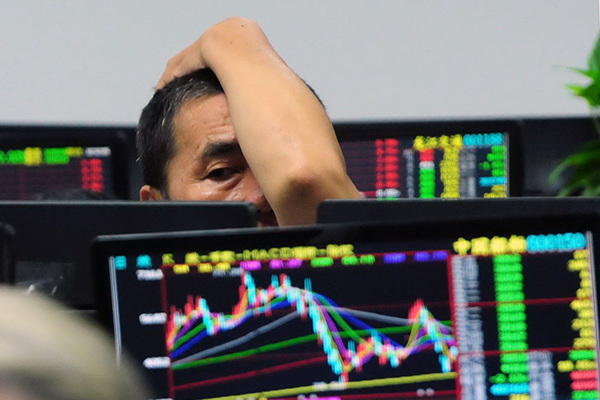 An investor checks stock prices at a brokerage in Jiujiang, Jiangxi province. Further crackdowns against market violation and manipulation are seen as being essential for restoring investor confidence. (Photo/China Daily)